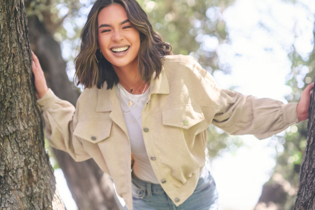 Jasmine Hollis showing a candid, fun smile in a bright lifestyle fashion portrait